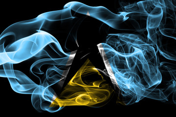 National flag of Saint Lucia made from colored smoke isolated on black background. Abstract silky wave background.