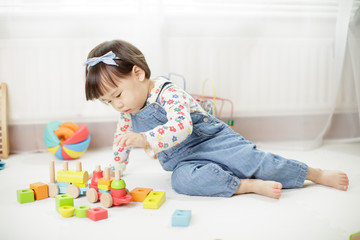 baby girl play toy blocks at home
