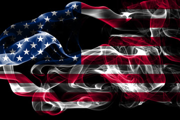 National flag of United States made from colored smoke isolated on black background. Abstract silky...