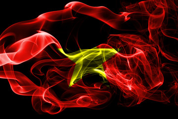 National flag of Vietnam made from colored smoke isolated on black background. Abstract silky wave background.