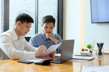 Business meeting with his partner two colleagues working with laptop computer on workplace.