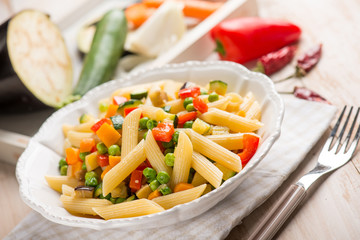 pasta with eggplants green peas zucchinis capsicum and carrot