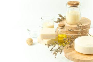 spa beauty prop with soap and oil and milk extract with dried flower on white background