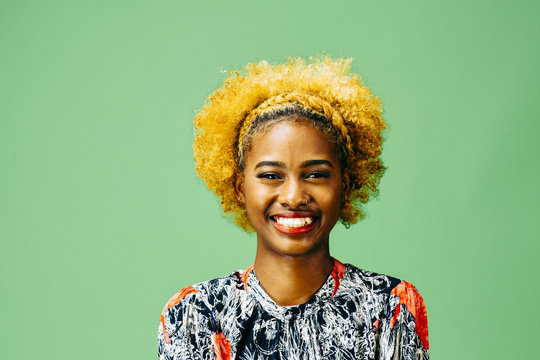 A Very Happy Young Girl With Big Smile, In Front Of A Green Background