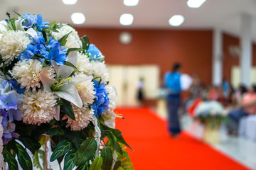 Artificial flowers decorated with red carpet.