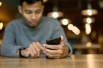 close up hand hold mobile cell phone device:focus on man play on smartphone concept	
