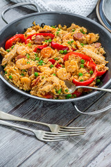 Spanish paella with prawns, chicken, chorizo and red pepper - high angle view