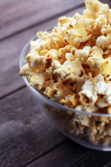 Cinema concept with popcorn on rustic table