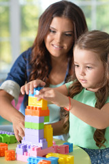 Portrait of a little girl playing with mother