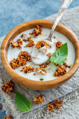 Natural yogurt with oat flakes and nuts in honey.