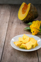 pumpkin on White plate put on old wood table