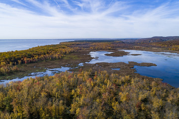 Aerial view over forest and marsh during vibrant autumn colors