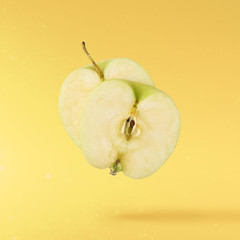 fresh apple Flying in air over yellow background