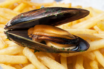 closeup of mussel on french fries background at restaurant