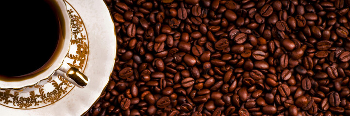 A cup of coffee on the background of coffee beans