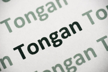 Fototapeta premium word Tongan language printed on paper macro