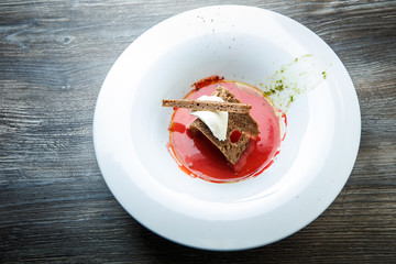 top view of ukrainian borscht decorated with brown bread and sour cream