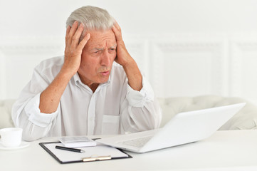Portrait of confident senior businessman working in office