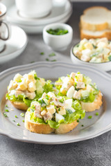 Sandwiches with squid meat salad, cucumber, egg, cheese and mayonnaise. Canapes in tartlets, Russian snack. Delicious food for Breakfast