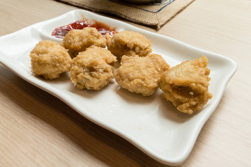 Golden fried chicken nuggets on white plate