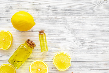 Organic cosmetics with natural ingredients. Lemon essential oil near halfs os lemons on white...
