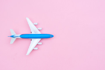 Plane on pink background with copy space