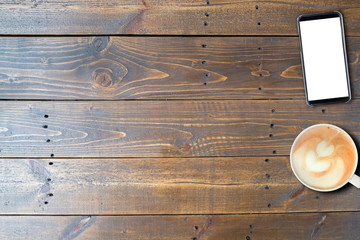 Mobile phone and hot coffee on wooden table, copy space, used for template