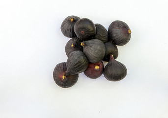 Fresh ripe sweet figs on white paper with copy space.