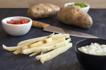 fresh cut fries and veggies on countertop