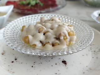 Hummus beans with Tehina on a glass plate