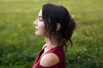 Portrait of a beautiful young woman in a red dress.