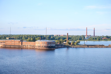 Fototapeta na wymiar Industrial buildings and smokestacks in St Petersburg from the water