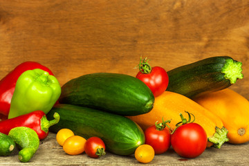 Fresh vegetables on an old wooden table. Harvest of vegetables. Healthy food. Raw food. Life on the farm.