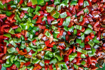 Food background, texture. Vegetarian useful mixture. Chopped bell peppers of different colors: red, green, yellow, black. Fresh vitamins and antioxidants, sweet peppers, vegetables 