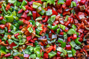 Food background, texture. Vegetarian useful mixture. Chopped bell peppers of different colors: red, green, yellow, black. Fresh vitamins and antioxidants, sweet peppers, vegetables 