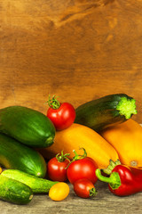 Fresh vegetables on an old wooden table. Harvest of vegetables. Healthy food. Raw food. Life on the farm.
