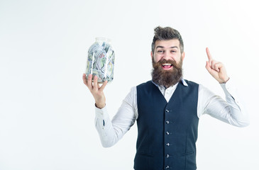 Businessman holds jar full of money banknotes. Business man raised finger up holds jar with dollars. Retirement fund, savings concept. Business, investment, finance, money saving for future concepts.