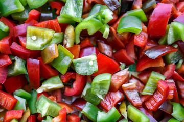 Food background, texture. Vegetarian useful mixture. Chopped bell peppers of different colors: red, green, yellow, black. Fresh vitamins and antioxidants, sweet peppers, vegetables 
