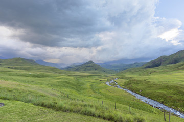 Rain on the mountain and the river flowing in a green valley