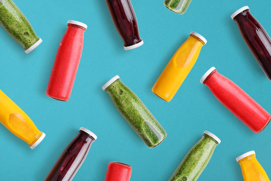 Colorful smoothies in glass bottles