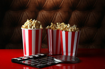 Popcorn in a striped box. Movie eating in theater