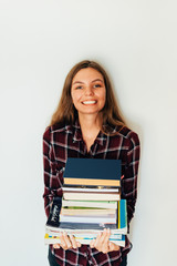 Pretty teen gild student of school or college with stack of books education