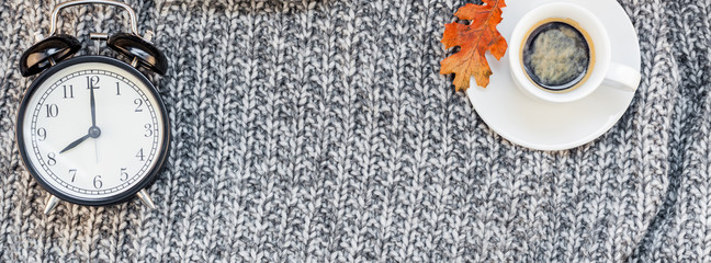 Home workplace with coffee cup on knitted plaid