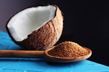 scoop of brown sugar with coconut on blue background