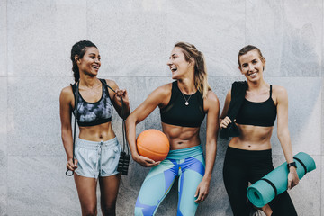 Smiling fitness women standing outdoors after workout - obrazy, fototapety, plakaty