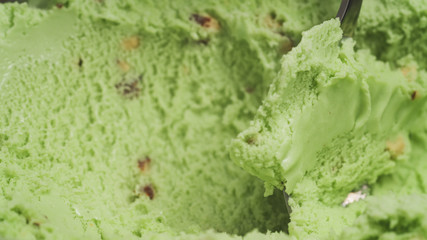 Close-up pistachio ice cream background scooping