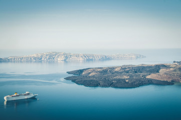 Beautiful landscape with sea view. Cruise liner at the sea near the Nea Kameni, a small Greek...