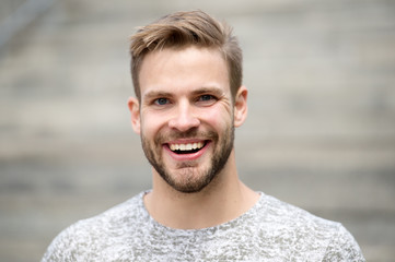 Man with perfect brilliant smile unshaven face defocused background. Guy happy emotional expression outdoors. Bearded and handsome. Man happy smiling face white brilliant teeth. Dentistry concept