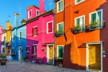 Fototapeta na wymiar Beautiful view of the canals of Burano with boats and beautiful, colorful buildings. Burano village is famous for its colorful houses. Venice, Italy.