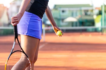 Fototapeten Young woman practicing serve on outdoor tennis court. © hedgehog94